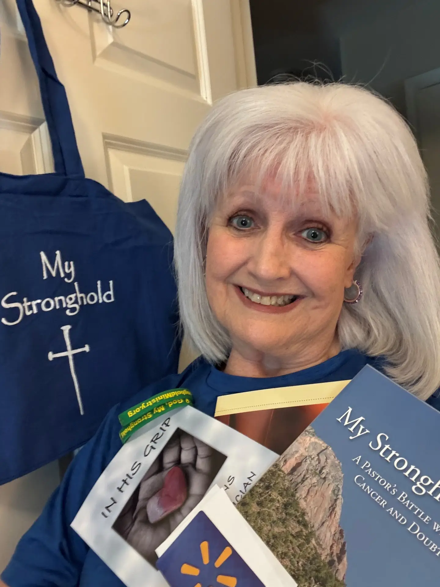 Female Cancer patient displaying contents of Stronghold Ministry gift basket